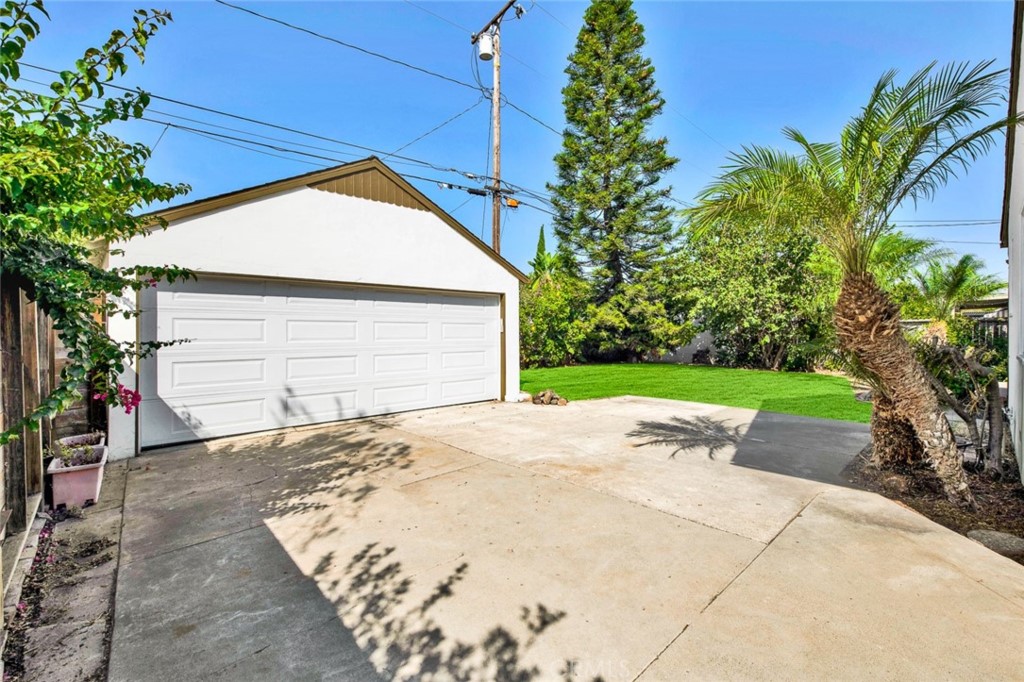 1722 North Flower Street Santa Ana, CA 92706 - Photo 25 of 25 a view of yellow house with a yard and potted plants