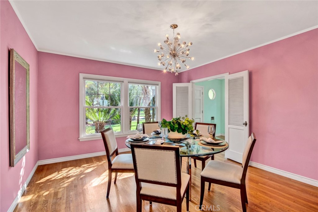 1722 North Flower Street Santa Ana, CA 92706 - Photo 7 of 25 a view of a dining room with furniture a chandelier and wooden floor
