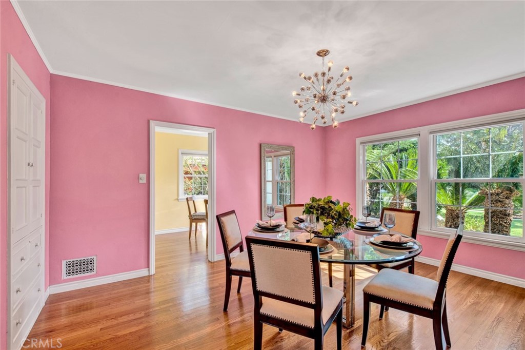 1722 North Flower Street Santa Ana, CA 92706 - Photo 8 of 25 a dining room with furniture a large window and wooden floor