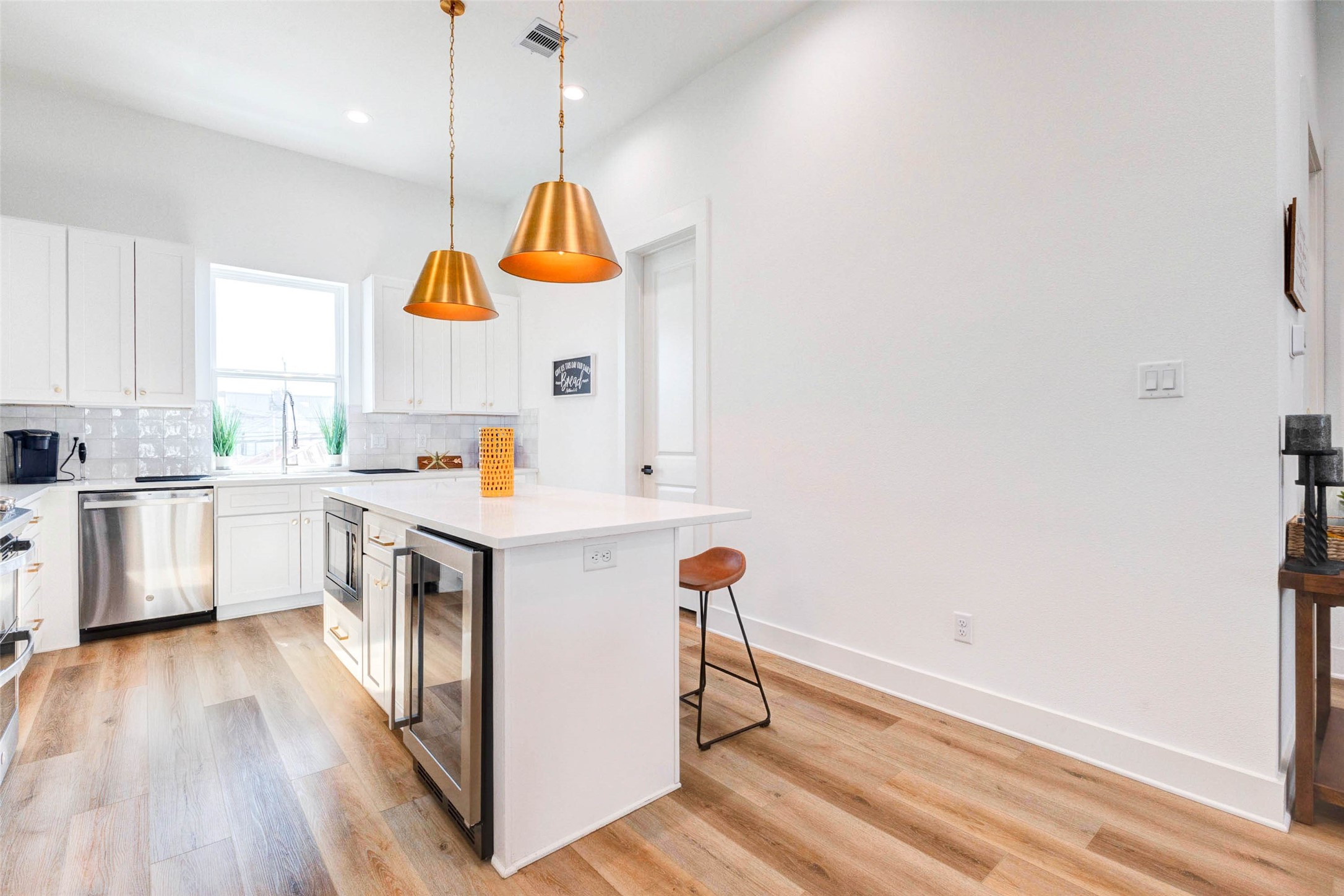 1307 East 27th Street, Unit A Houston, TX 77009 - Photo 15 of 48 a kitchen with a sink cabinets stainless steel appliances and a window