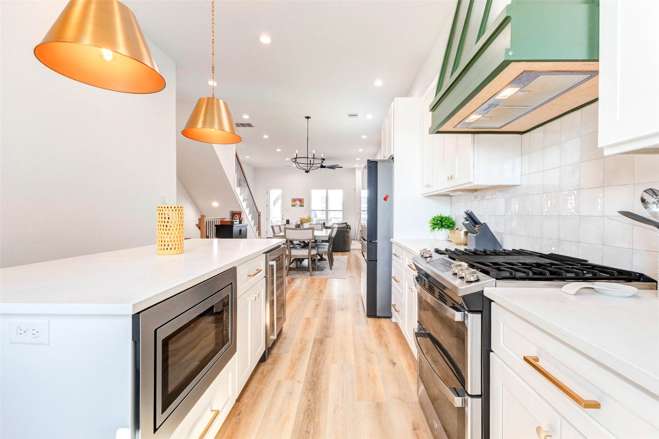 1307 East 27th Street, Unit A Houston, TX 77009 - Photo 19 of 48 a kitchen with a stove a sink and a refrigerator