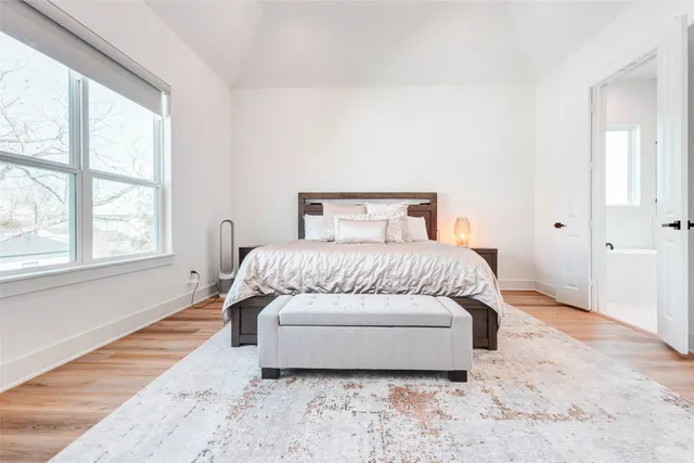 a spacious bedroom with a bed and a window