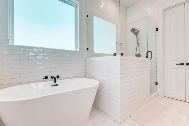 a bathroom with a bathtub and shower