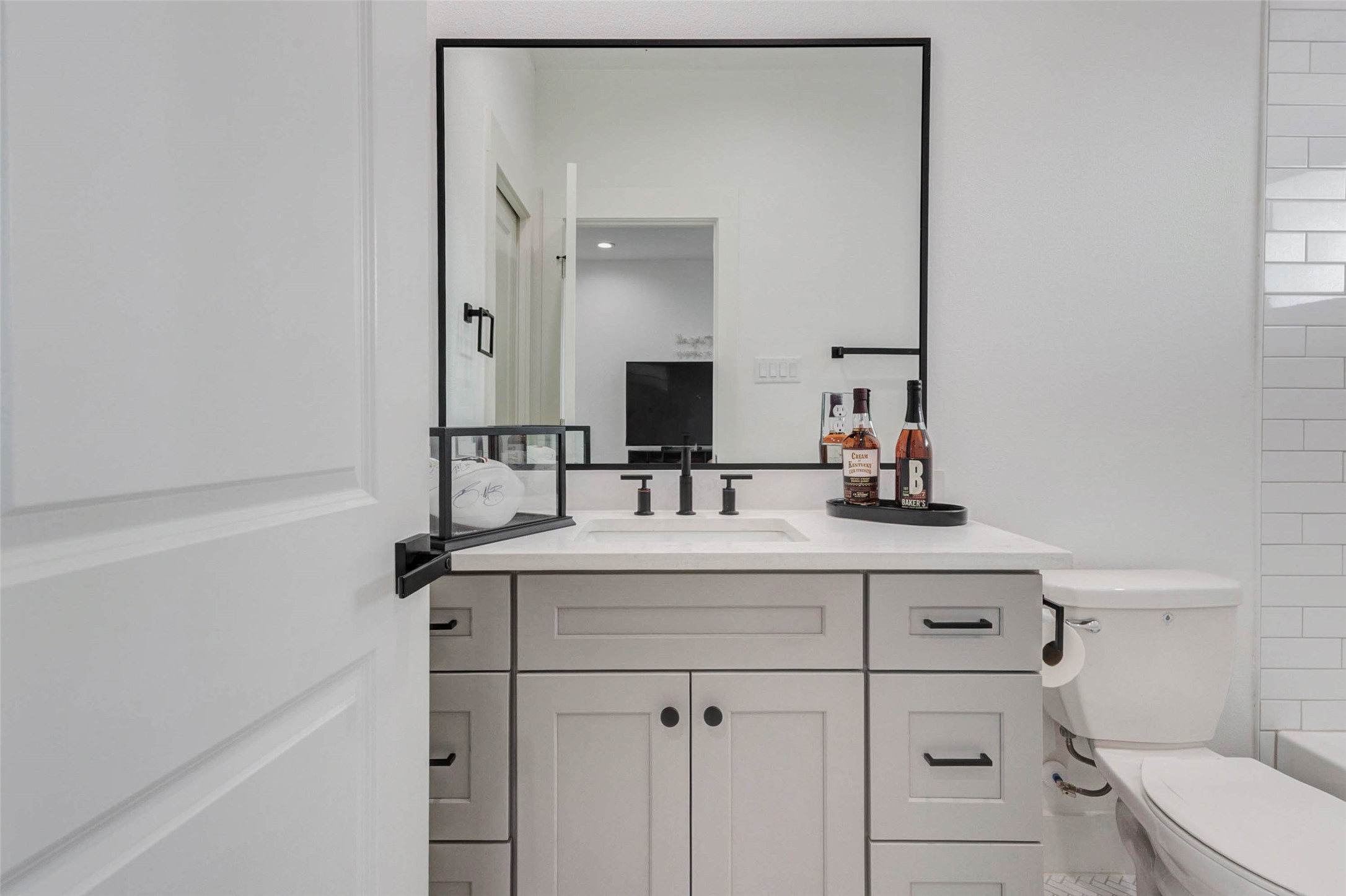 1307 East 27th Street, Unit A Houston, TX 77009 - Photo 10 of 48 a bathroom with a sink vanity toilet and mirror