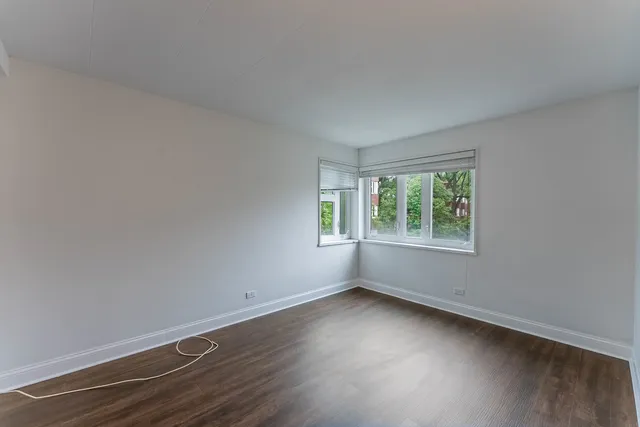 a view of a room with wooden floor and window