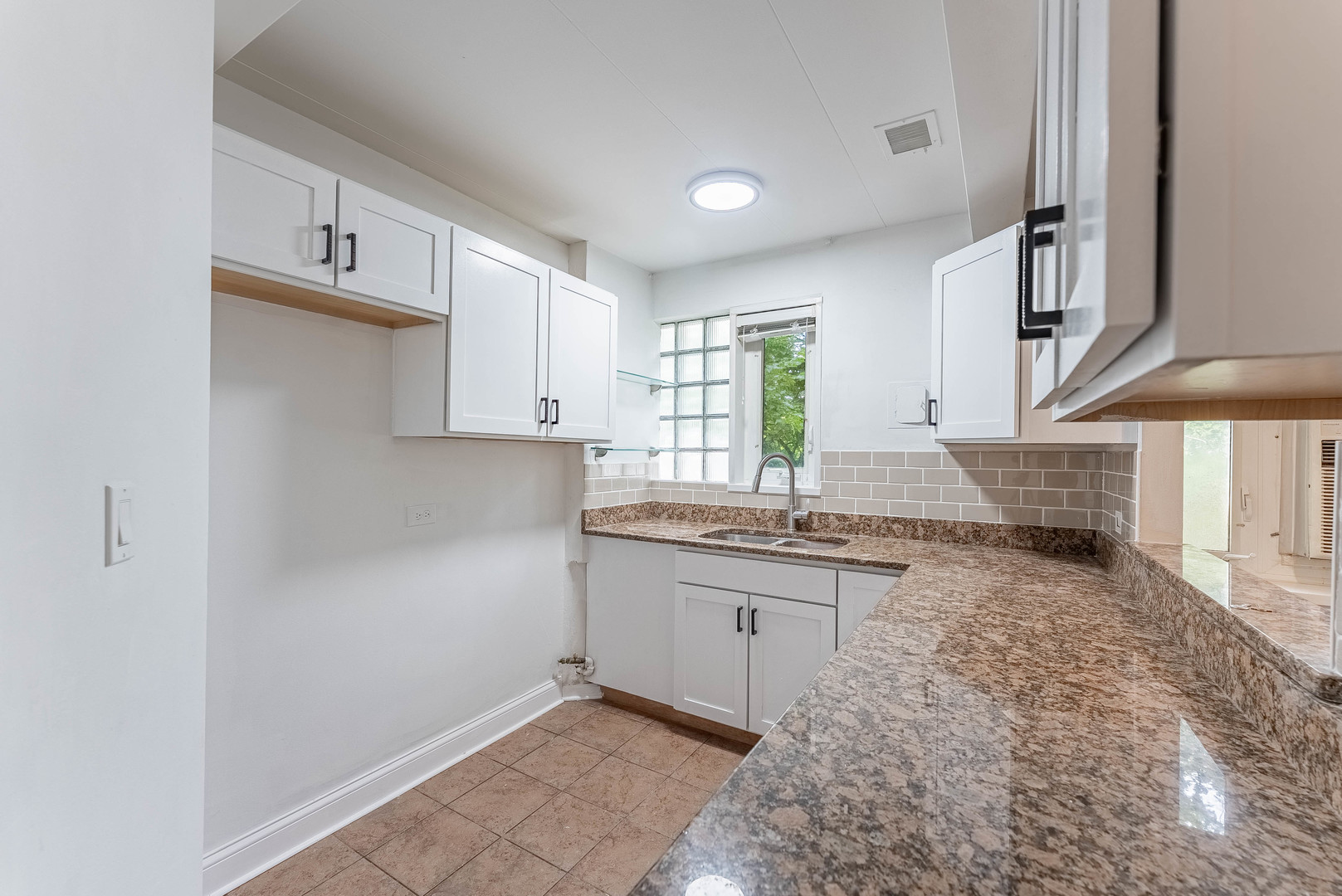 7200 Oak Avenue, Unit 3NW River Forest, IL 60305 - Photo 7 of 9 a kitchen with granite countertop a sink and cabinets