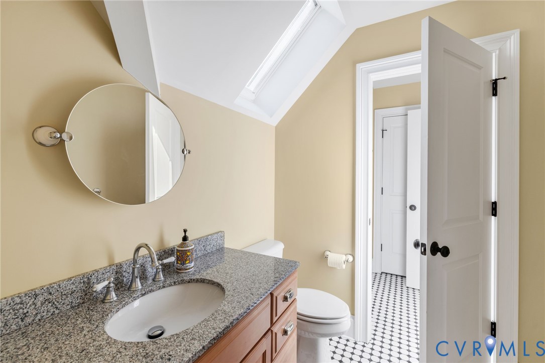 8947 Cherokee Road Richmond, VA 23235 - Photo 36 of 45 a bathroom with a sink a toilet and a mirror