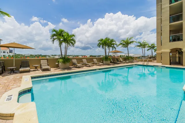 a view of a swimming pool and lounge chairs