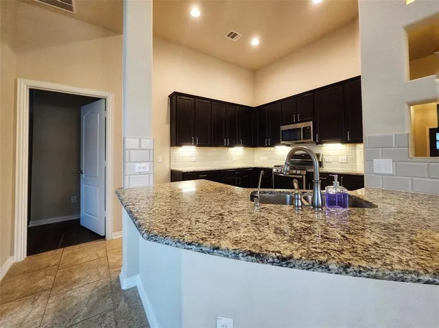 a view of a kitchen with a large window