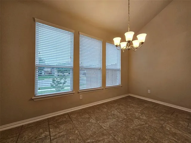 a kitchen with kitchen island granite countertop a sink stove and refrigerator