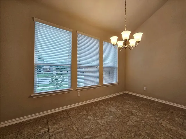 a kitchen with kitchen island granite countertop a sink stove and refrigerator