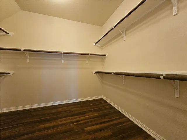 a bathroom with a double vanity sink a mirror and a bathtub