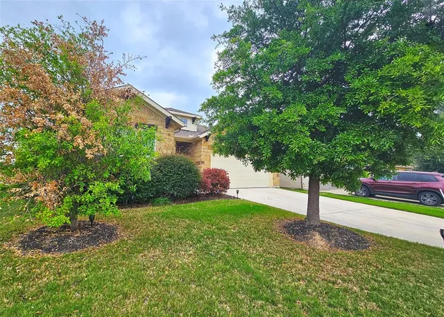 a view of a garden with a house