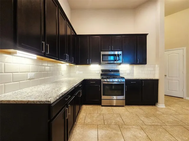 a kitchen with a sink and a stove top oven