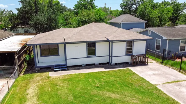 a aerial view of a house with a yard table and chairs