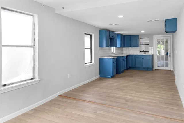 a kitchen with stainless steel appliances kitchen island granite countertop a refrigerator sink and cabinets