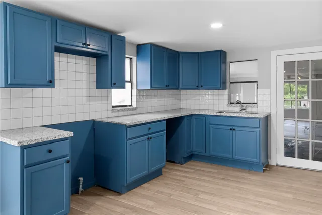 a kitchen with a sink dishwasher and wooden cabinets