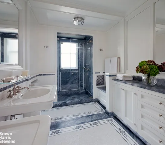 a spacious bathroom with a granite countertop sink and a mirror
