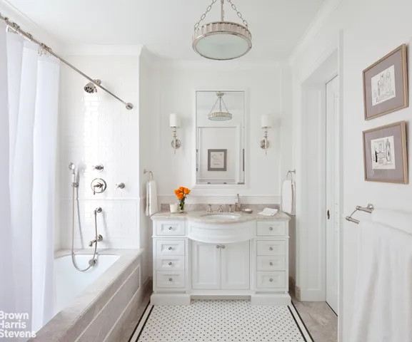a spacious bathroom with a double vanity sink a mirror a shower and a bathtub