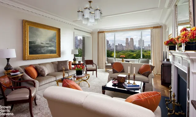 a living room with furniture fireplace and a large window