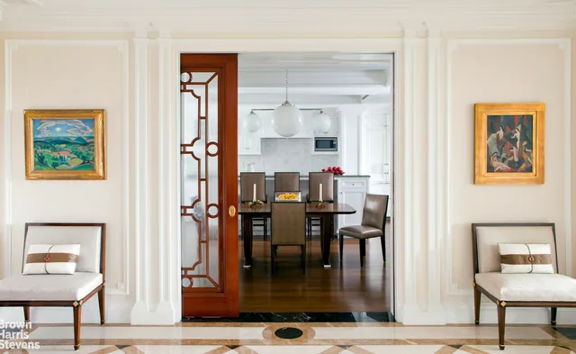 a dining room with wooden floor and windows