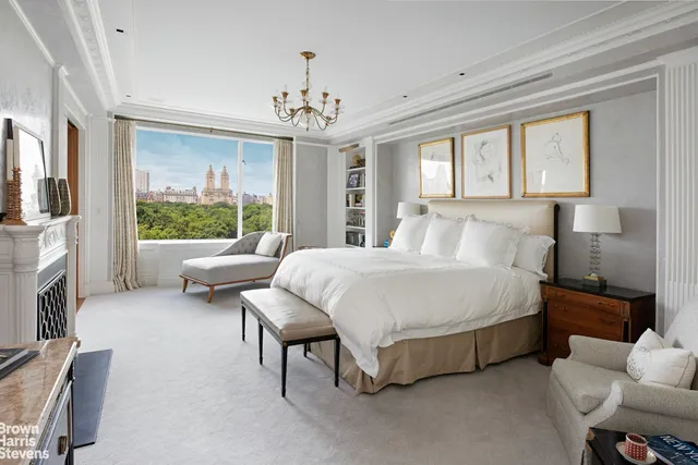 a spacious bedroom with a bed and a chandelier