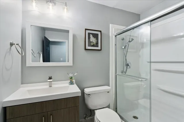 a bathroom with a sink toilet and shower