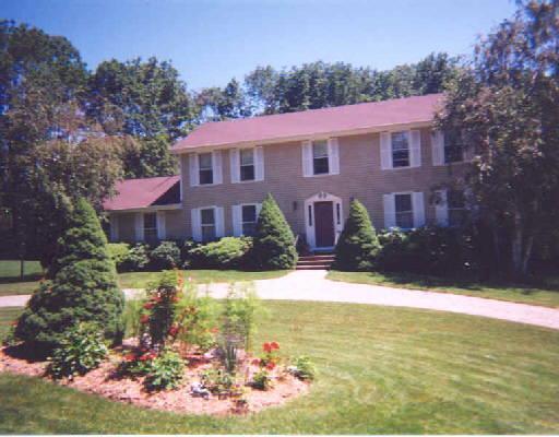 a view of a house with swimming pool next to a yard