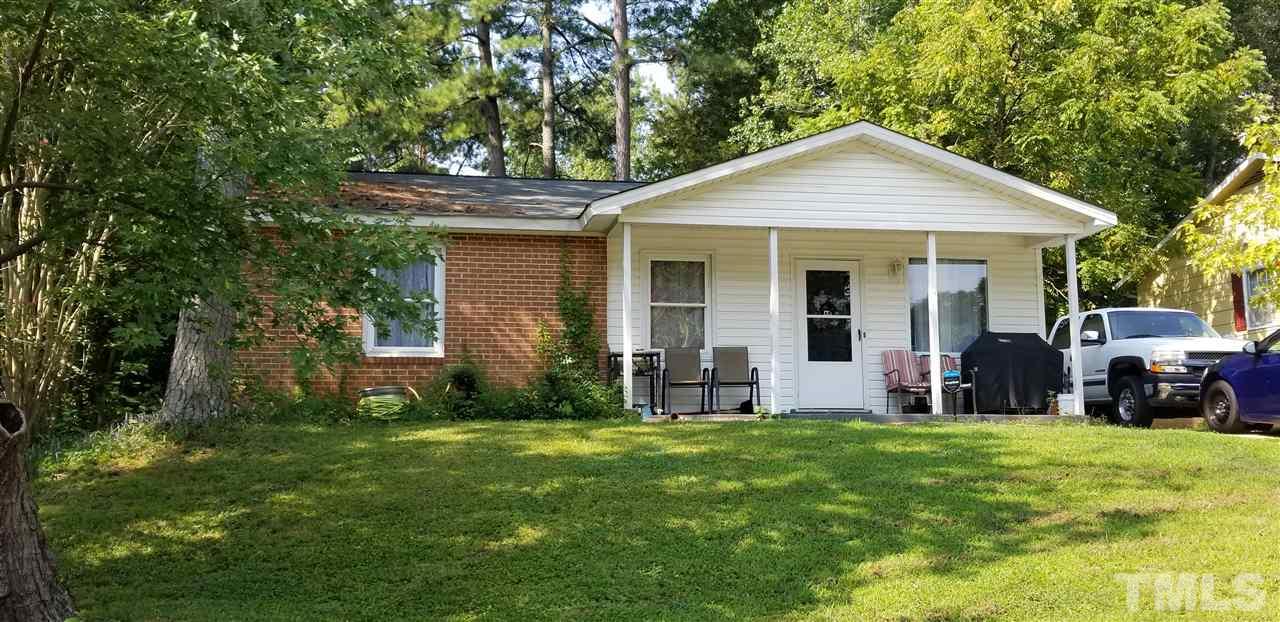 7512 Stuart Drive Raleigh, NC 27615 - Photo 1 of 9 a front view of house with yard and green space