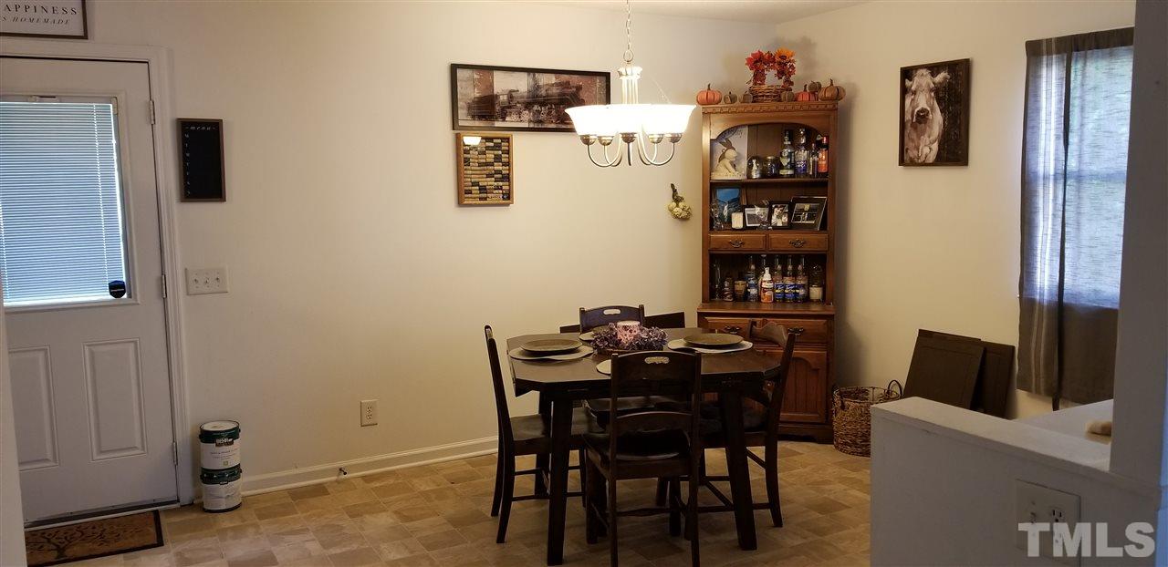 7512 Stuart Drive Raleigh, NC 27615 - Photo 5 of 9 a view of a dining room with furniture