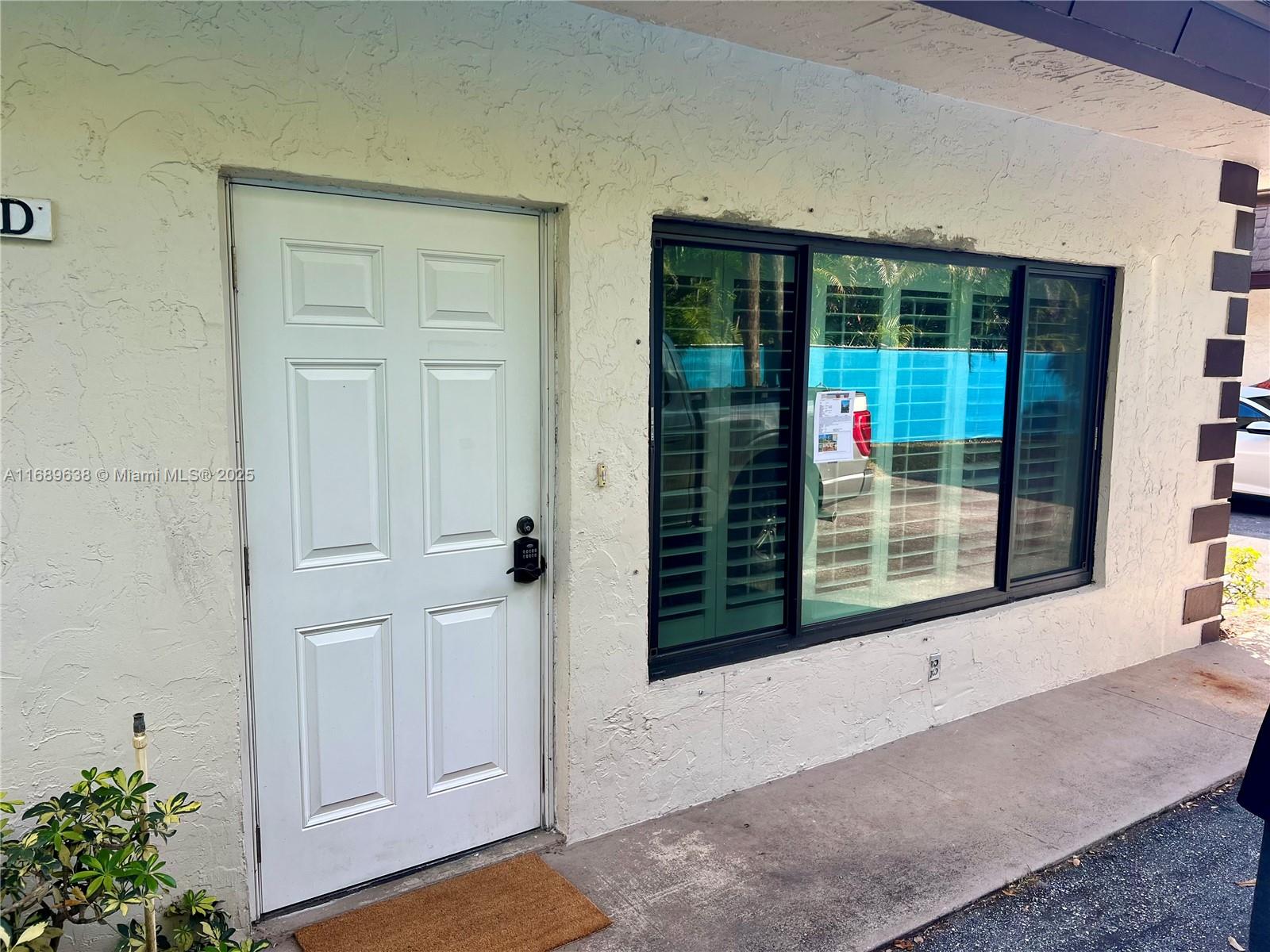 9290 Southwest 61st Way, Unit D Boca Raton, FL 33428 - Photo 3 of 38 a view of a door of the house