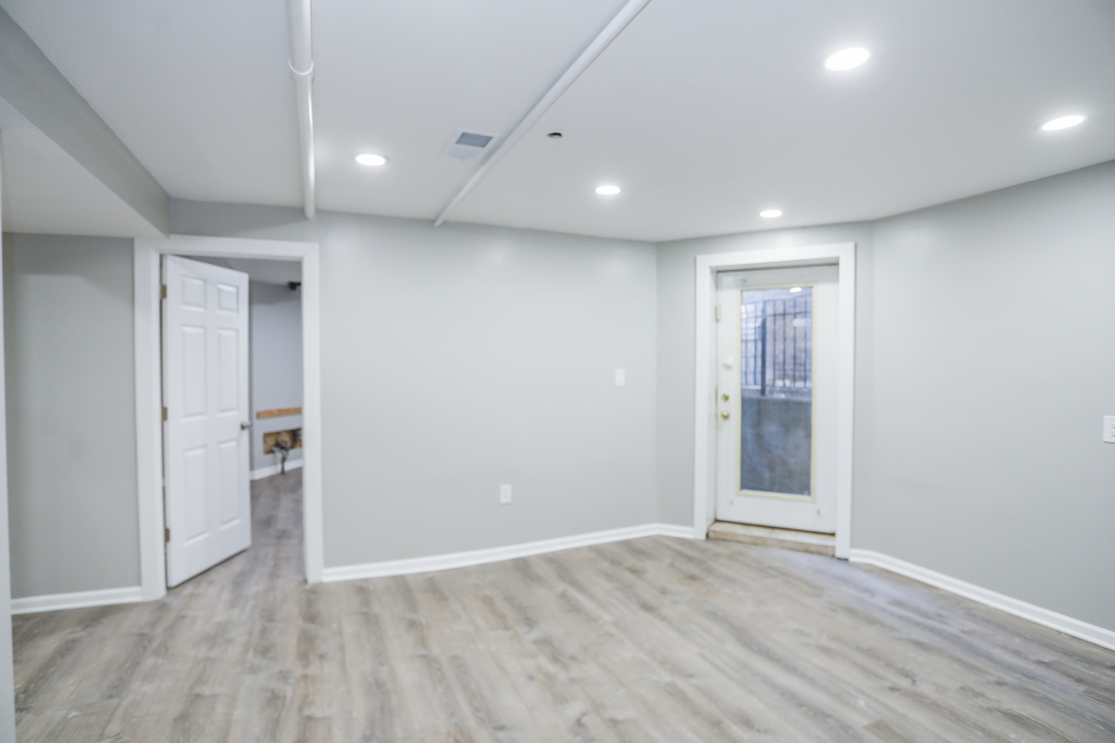 1315 West Eddy Street, Unit G Chicago, IL 60657 - Photo 6 of 9 wooden floor in an empty room with a window