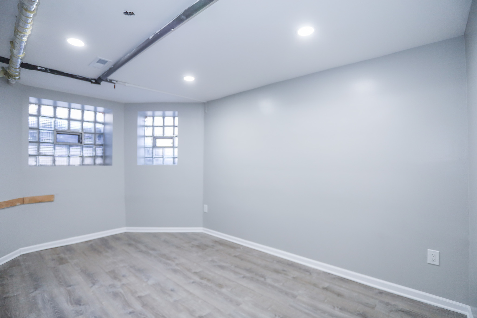 1315 West Eddy Street, Unit G Chicago, IL 60657 - Photo 8 of 9 an empty room with wooden floor and windows
