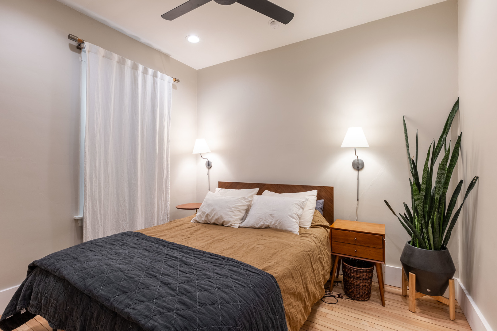 Undisclosed Address Chicago, IL 60647 - Photo 17 of 42 a bedroom with a bed table chair and a potted plant
