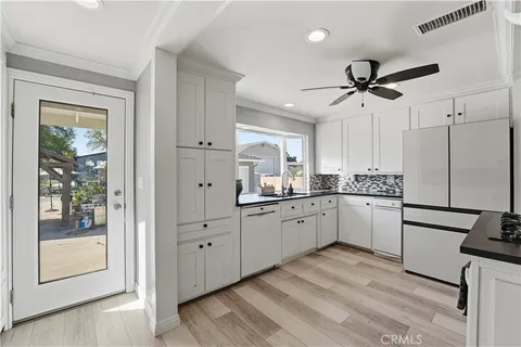 a kitchen with granite countertop a sink stainless steel appliances and cabinets