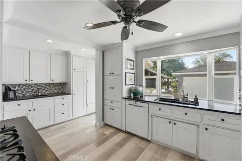 a kitchen with white cabinets and stainless steel appliances