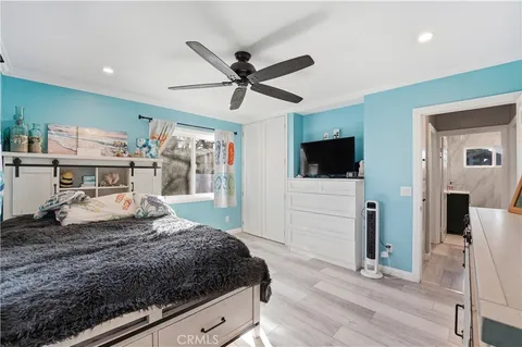 a bedroom with a large bed and a ceiling fan