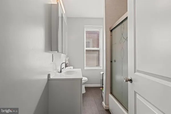 a bathroom with a sink toilet and shower