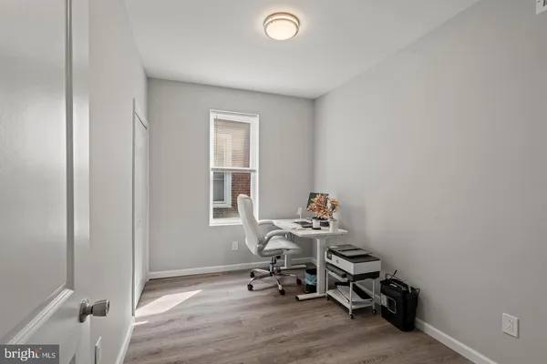a workspace with wooden floor and a window