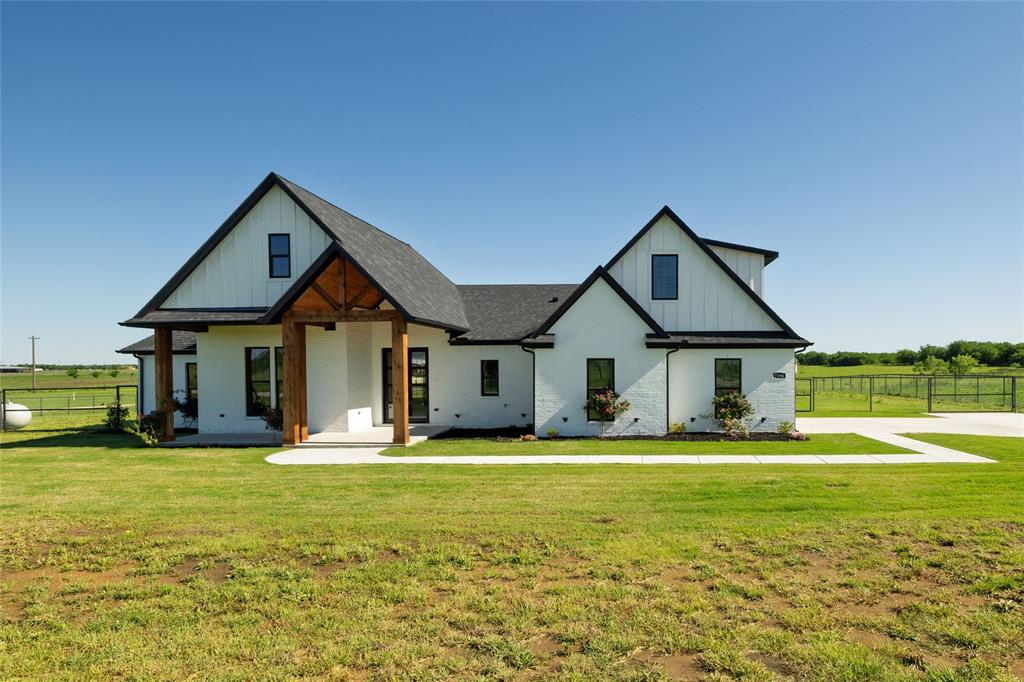 7196 Hawkeye Road Sanger, TX 76266 - Photo 1 of 1 Modern farmhouse style home featuring fence, a front lawn, and board and batten siding