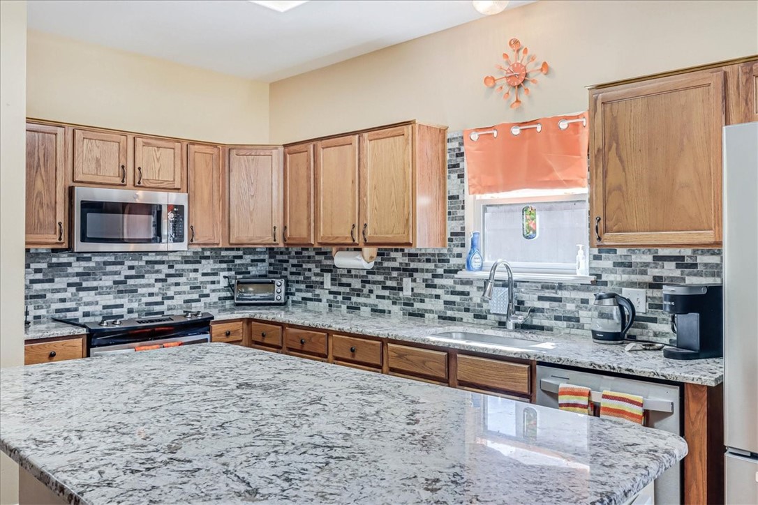5801 Corsica Road Corpus Christi, TX 78414 - Photo 11 of 39 a kitchen with granite countertop a sink and a stove