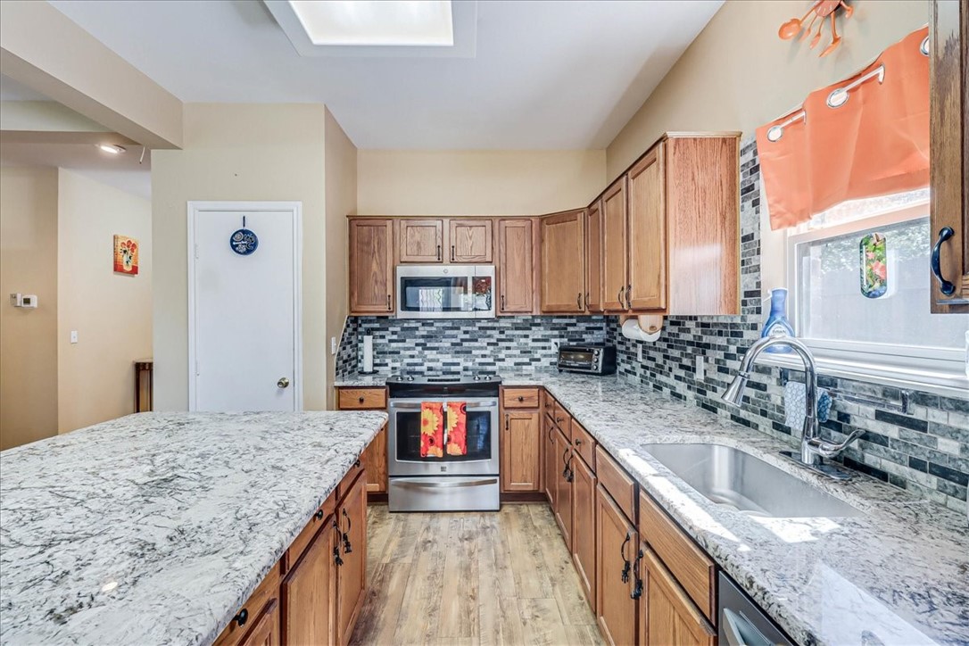 5801 Corsica Road Corpus Christi, TX 78414 - Photo 12 of 39 a kitchen with stainless steel appliances granite countertop a sink stove and refrigerator