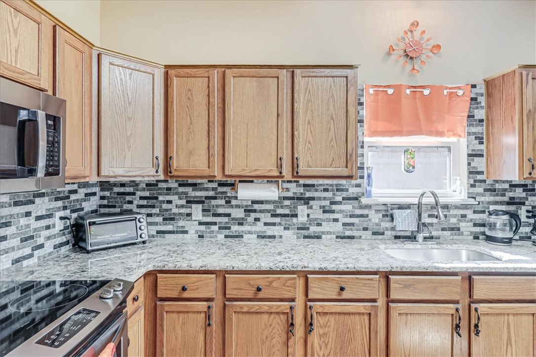 5801 Corsica Road Corpus Christi, TX 78414 - Photo 13 of 39 a kitchen with granite countertop a sink and a stove