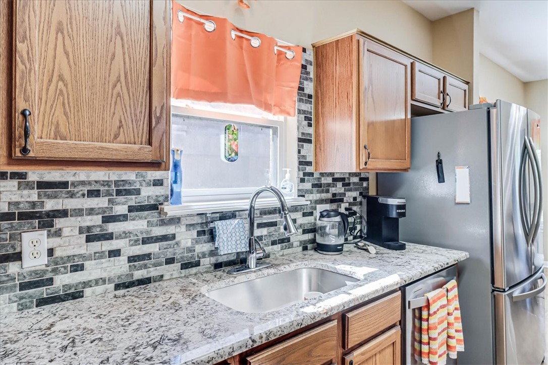 5801 Corsica Road Corpus Christi, TX 78414 - Photo 14 of 39 a kitchen with stainless steel appliances granite countertop a sink a refrigerator and a granite counter tops