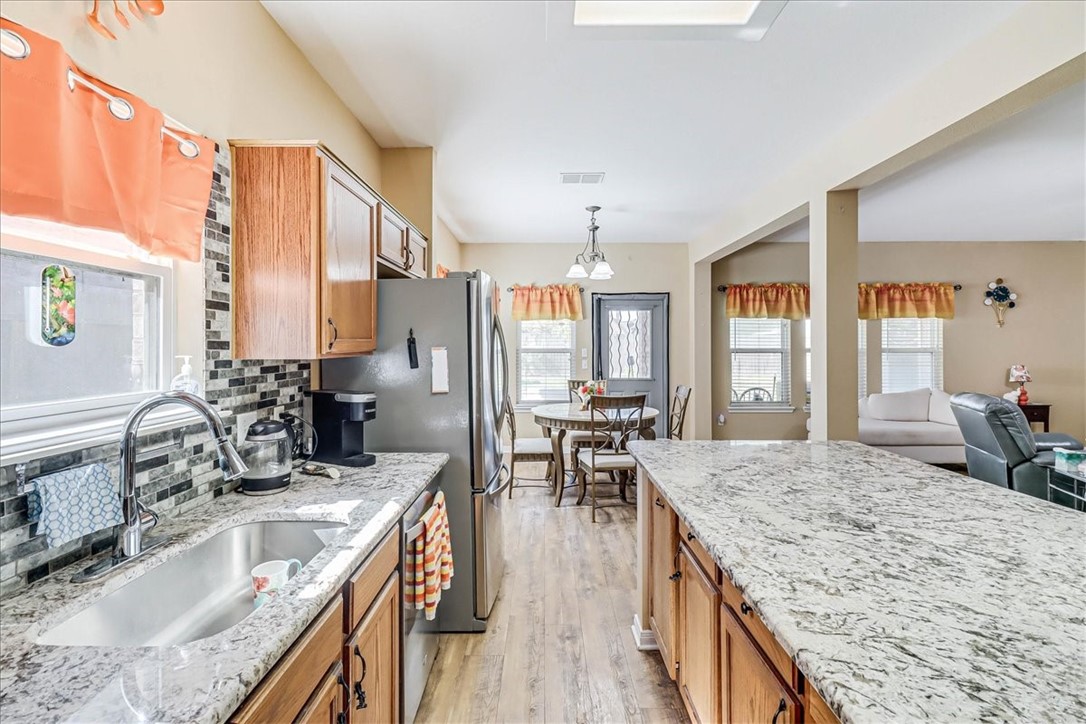 5801 Corsica Road Corpus Christi, TX 78414 - Photo 15 of 39 a kitchen with granite countertop a sink stove and refrigerator