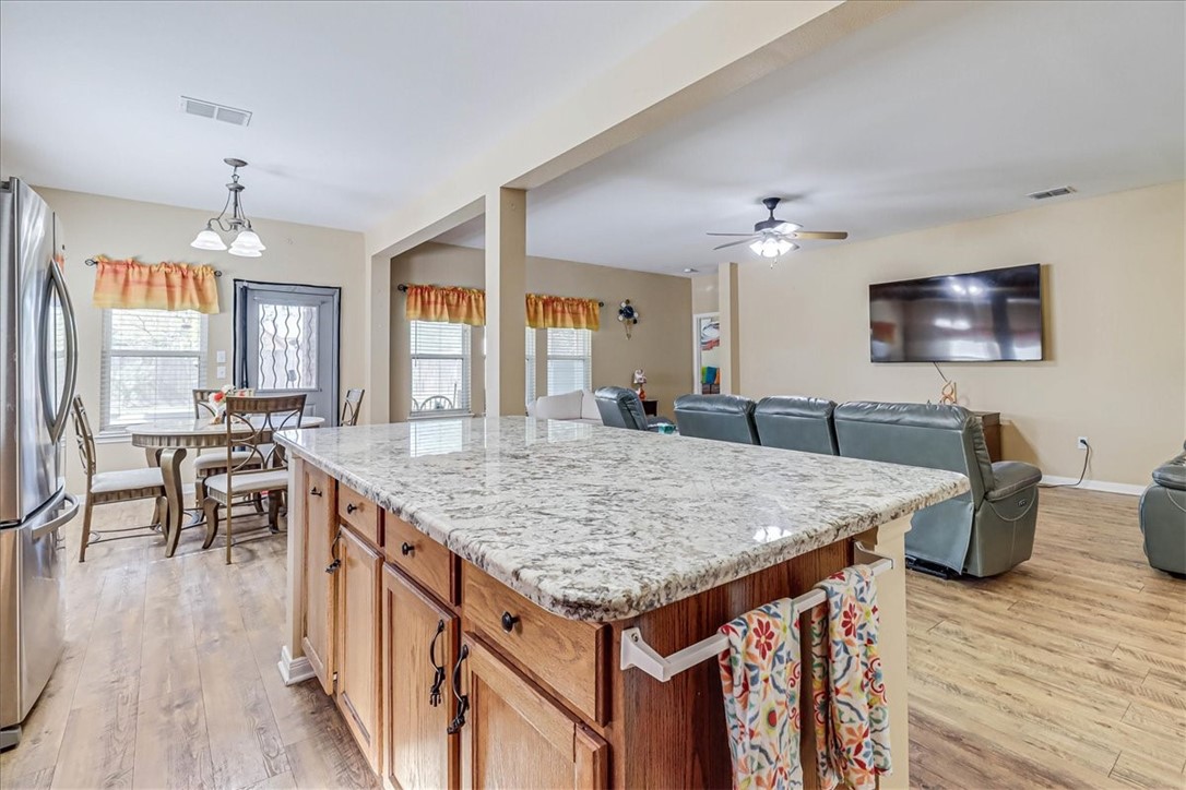 5801 Corsica Road Corpus Christi, TX 78414 - Photo 16 of 39 a view of kitchen island wooden floor and living room