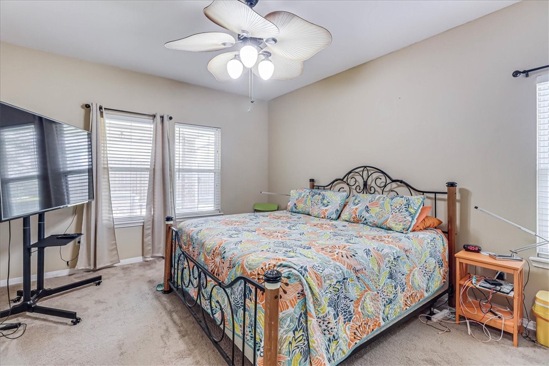 5801 Corsica Road Corpus Christi, TX 78414 - Photo 21 of 39 a bedroom with a bed a chandelier and dresser