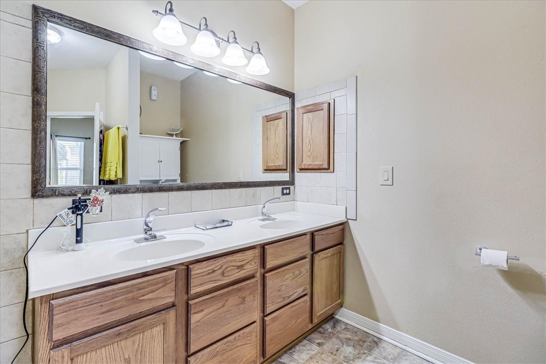 5801 Corsica Road Corpus Christi, TX 78414 - Photo 22 of 39 a bathroom with a double vanity sink and a mirror