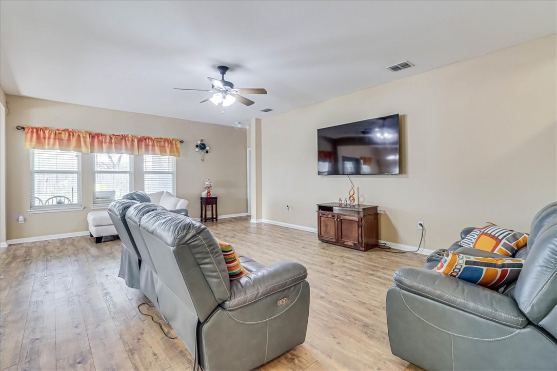 5801 Corsica Road Corpus Christi, TX 78414 - Photo 6 of 39 a living room with furniture a ceiling fan and a flat screen tv