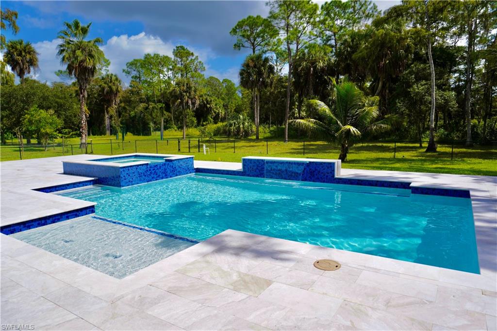 428 21st Street Southwest Naples, FL 34117 - Photo 11 of 45 a view of swimming pool with a yard